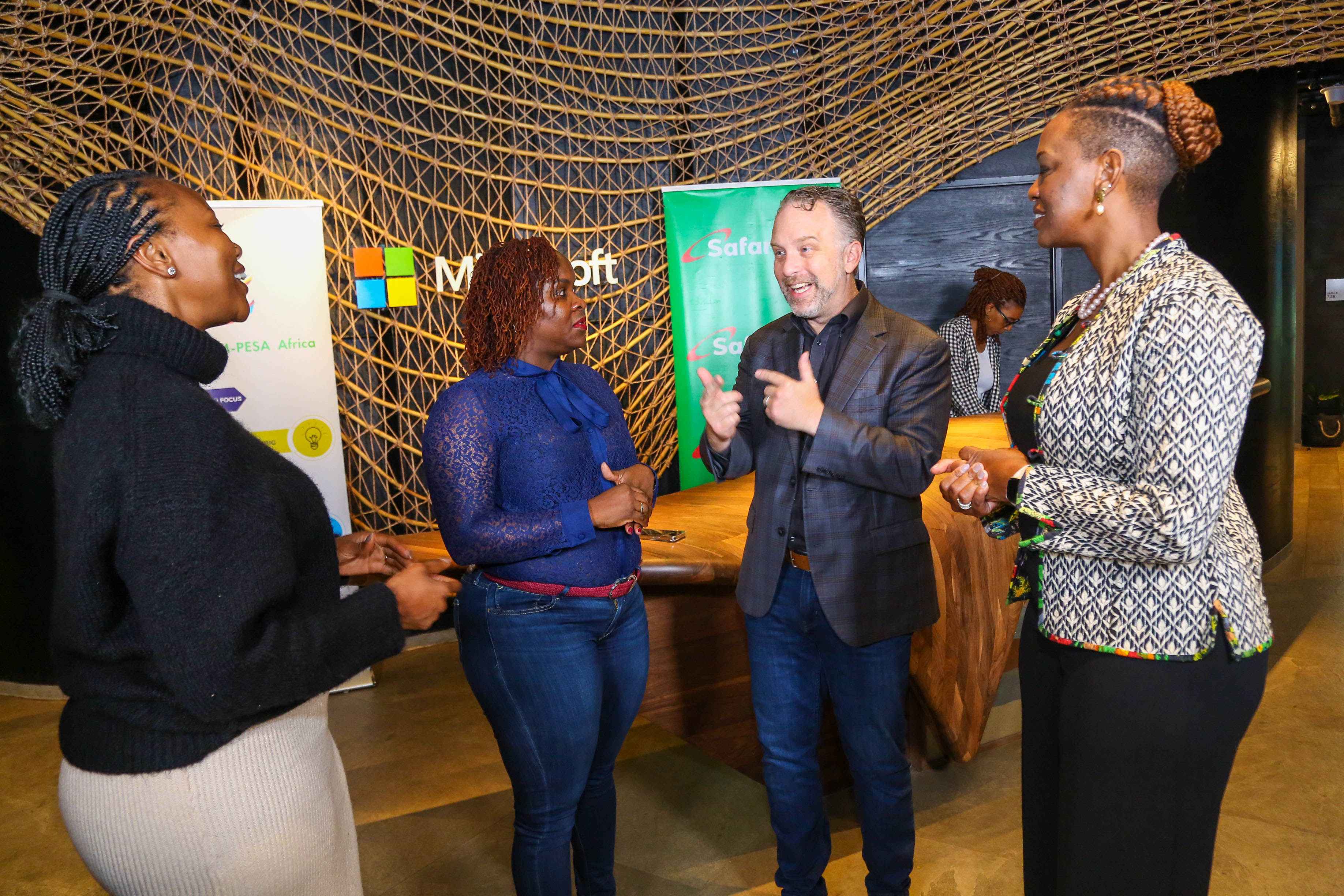 Safaricom PLC Chief Financial Services Officer, Esther Waititu (second right) shakes hands with Vice President- Microsoft Tech for Social Impact (TSI), Justin Spelhaug during the partnership meeting at Dunhill Towers.